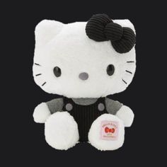 a white hello kitty stuffed animal on a black background