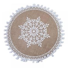 a round rug with white pom - poms on the bottom and a beige background