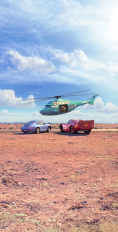 a helicopter flying over two cars in the desert