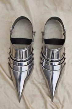 four pairs of silver shoes with spikes on them