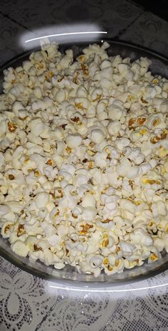 a bowl filled with popcorn sitting on top of a table