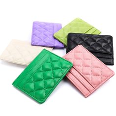 four different colored wallets sitting on top of each other