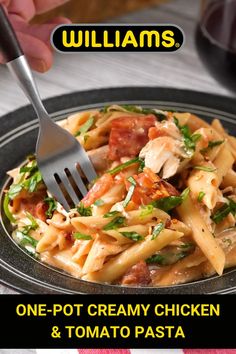 a person holding a fork over a plate of pasta