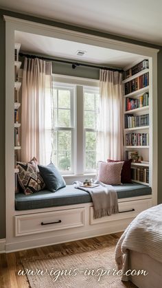 a window seat in the corner of a bedroom with bookshelves on either side