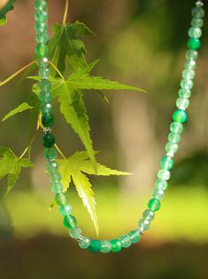 This elegant necklace features a stunning combination of small silver beads and gradient green jadeite to create a captivating multi-element design. Each bead is carefully strung together to create a harmonious composition, and the gradient green jade adds a touch of energy and elegance to the necklace, while the various elements create visual interest and depth. Metal: Recycled Sterling Silver Plated On Brass Gemstone: Green Strawberry Quartz 7mm,Green Chalcedony 7.5mm Length: 390mm Weight: 29g Green Aventurine Beaded Necklace With Polished Beads, Green Aventurine Round Beaded Necklaces, Green Aventurine Round Beaded Necklace, Green Aventurine Beaded Necklaces, Green Crystal Necklaces With Polished Round Beads, Green Aventurine Crystal Necklaces With Round Beads, Green Single Strand Spiritual Beaded Necklace, Green Crystal Necklace With Round Gemstone Beads, Green Crystal Necklaces With Round Gemstone Beads