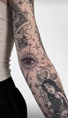 a woman's arm with tattoos on it and an eye in the sky above her