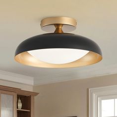 a black and gold ceiling light in a kitchen