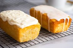 two pieces of cake sitting on top of a cooling rack