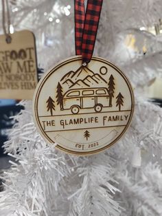 a wooden ornament hanging on a christmas tree with the words, the glamlife family