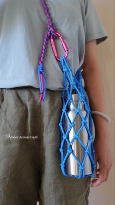 a person holding a blue and pink object in their hands