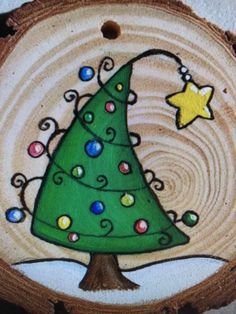 a painted christmas tree on a piece of wood