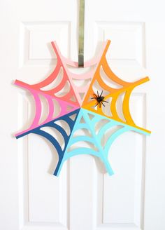 an image of a spider web on the door with text reading rainbow spider web wreath