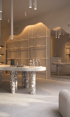 the interior of a retail store with marble tables and stools in front of shelves