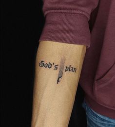 a person with a tattoo on their arm that says god's plan and an arrow