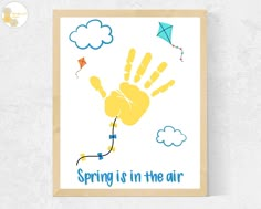 a poster with the words spring is in the air and a hand print on it