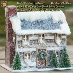 a small christmas house with snow on the roof