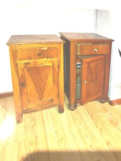 two wooden side tables sitting next to each other on top of a hard wood floor