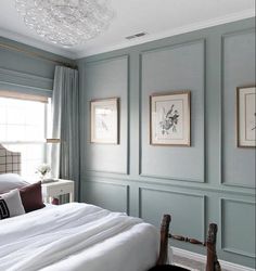 a bedroom with gray walls and white bedding