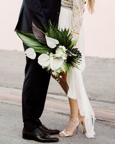 a bride and groom standing next to each other