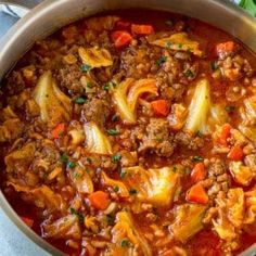 a pot filled with meat and vegetables on top of a table