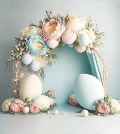 an easter wreath with flowers and eggs in it on a blue background royalty photo - illustration