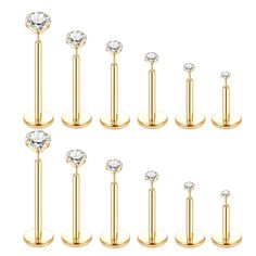 six pairs of gold plated stainless steel barbells with clear crystal stones on each end