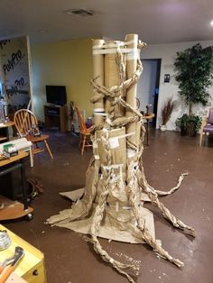 a pile of cardboard sitting on top of a wooden floor next to a tree stump