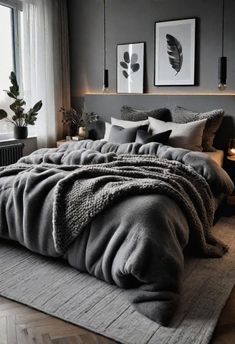 a large bed sitting next to a window covered in blankets and throw pillows on top of a rug