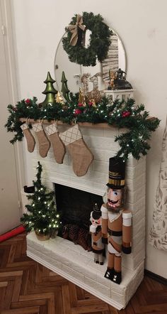 a fireplace decorated for christmas with stockings and stockings