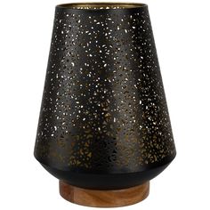 a black and gold vase on top of a wooden base with holes in it's center