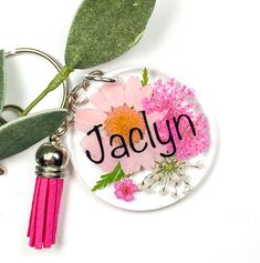 a keychain with flowers and the word jaclyn on it