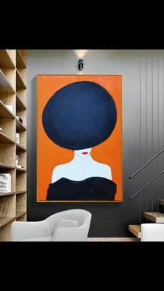 an orange and black painting on the wall above a chair