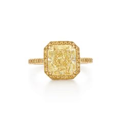 a fancy yellow diamond ring set in 18k gold