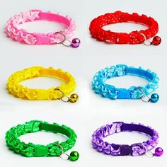 four different colored dog collars with bells