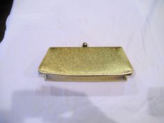 "This St. Thomas gold metallic clutch has a dinghy bag / coin purse inside.  It measures 10\" wide, 4\" tall, and 2\" deep. with a 12-1/2\" chain strap.   It has a dent on it but otherwise is very nice, from smoke free home." Gold Compact Party Bag, Metallic Rectangular Clutch For Formal Events, Metallic Rectangular Clutch For Formal Occasions, Gold Clutch With Gold-tone Hardware For Formal Events, Gold Clutch With Gold-tone Hardware For Formal Occasions, Metallic Clutch For Formal Occasions, Formal Gold Clutch With Gold-tone Hardware, Gold Pouch Evening Bag With Gold-tone Hardware, Gold Clutch With Gold-tone Hardware For Events