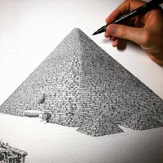 a drawing of a pyramid with a person's hand holding a pencil in front of it