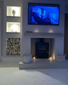 a flat screen tv mounted above a fireplace