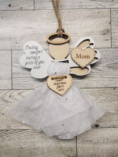 some wooden hearts and other decorations on a wood floor with words that say mom, i love you