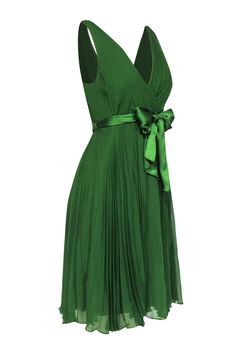 You will surely look as beautiful as a precious stone in this lovely emerald green mini dress from Rebecca Taylor. The pleated chiffon offers soft and floaty movement when you are wearing it. The soft fabric and movement will have you wearing this piece with elegance and delicacy. Pair with a matching emerald heel for any of your upcoming dressy events. Size 6 Shell & Lining: 100% Silk Concealed side zipper Fully lined A-line silhouette Surplice V-neckline Pleated detail Satin waist belt Bust 33 Chic Green A-line Chiffon Dress, Green A-line Mini Dress For Wedding, Pleated A-line Chiffon Party Dress, Elegant Chiffon A-line Pleated Dress, Green Flowy A-line Chiffon Dress, Elegant Dark Green Sleeveless Mini Dress, Elegant Sleeveless Dark Green Mini Dress, Elegant A-line Chiffon Dress With Pleated Bodice, Elegant Flowy Pleated Chiffon Dress