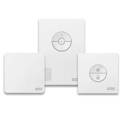 three white square coasters sitting next to each other on top of a white surface