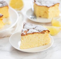 two slices of lemon cake on white plates