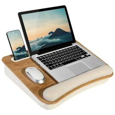 an open laptop computer sitting on top of a wooden desk next to a mouse pad