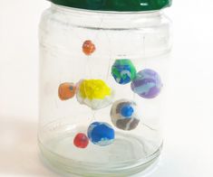 a jar filled with lots of different colored balls