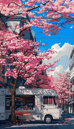 a food truck parked on the side of a road next to a tree filled with pink flowers