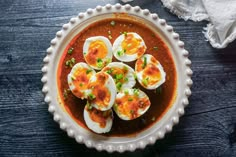 an overhead shot of deviled eggs in tomato sauce