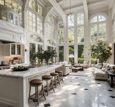 a large kitchen with lots of windows and white furniture