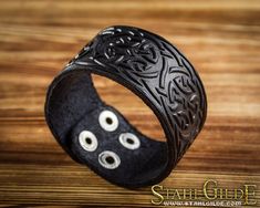 "This leather Bracelet Cuff is embossed with Celtic knotwork design. The size of leather Bracelet: Measures 37 mm (1'' 7/16) wide with two snaps that offer an adjustable length of approximately 18.5 cm (7'' 1/4) and 20 cm (7' 3/4'). The Total lenght is 8'' 1/2 The inner diameter is minimum for wrist 16cm (6''.26), maximum - 18cm (7\") The leather cuff bracelet fits for any size of most adults and teens. Celtic knots are endless paths and so represent eternity and never ending this can be in love Leather Wristbands Celtic, Celtic Knotwork Design, Celtic Braid, Protective Talisman, Arm Guard, Celtic Knotwork, Viking Bracelet, Leather Wristbands, Leather Cuffs Bracelet