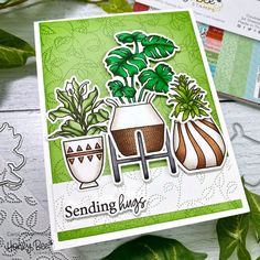 a card with potted plants on it and some other cards in the background next to them