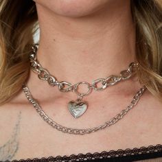 Unleash your inner romantic with our Large Silver Heart & Chain Layered Necklace Set. Featuring a stunning large silver heart pendant and two Cuban style chain layers, this set is perfect for adding a touch of edge to any outfit. Make a statement with this unique and versatile accessory. Good to Know: Can be worn at a variety of lengths Charm Size: 30mm long x 16mm wide Silver Plated Unisex Sizing Short necklace - 16" Long necklace - 20" Chain Layered Necklace, Cuban Style, Layered Necklace Set, Silver Heart Pendant, Heart Chain, Layered Necklace, Short Necklace, Silver Heart, Layered Necklaces