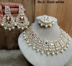 *Light Weight Kundan layered necklace set with earrings and tikka. *Studded with kundan stone. *Light Weight Gold kundan necklace. *No.1-  * Necklace width- 1.4 inches( Included drops) *Earrings Length- 2.6 inches(included pearl drop) *Earrings width Size- 1.4 inches *No.2-  * Necklace width- 1.1 inches( Included drops) *Earrings Length- 3.4 inches(included pearl drop) *Earrings width Size- 1.6 inches White Kundan Necklace With Stone Work For Party, Bollywood Style White Tikka For Diwali, White Bollywood Tikka For Diwali, Heavy Bollywood Bridal Necklace In White, Heavy White Jewelry Sets For Festive Season, Heavy Bollywood Style Bridal Necklace In White, Heavy White Jewelry Sets For Festive Occasions, Bollywood Style Festive White Jewelry Sets, Bollywood Style White Chandbali Bridal Necklace